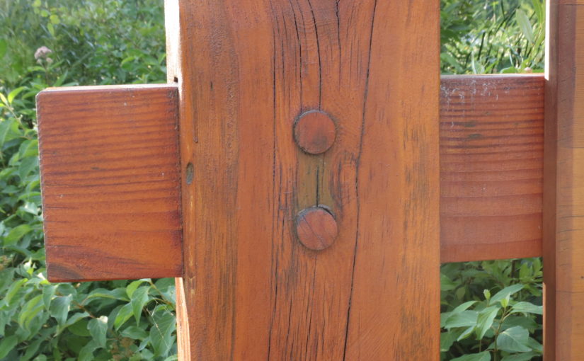Up close photo of a 2 wood members joined with round wood peg.